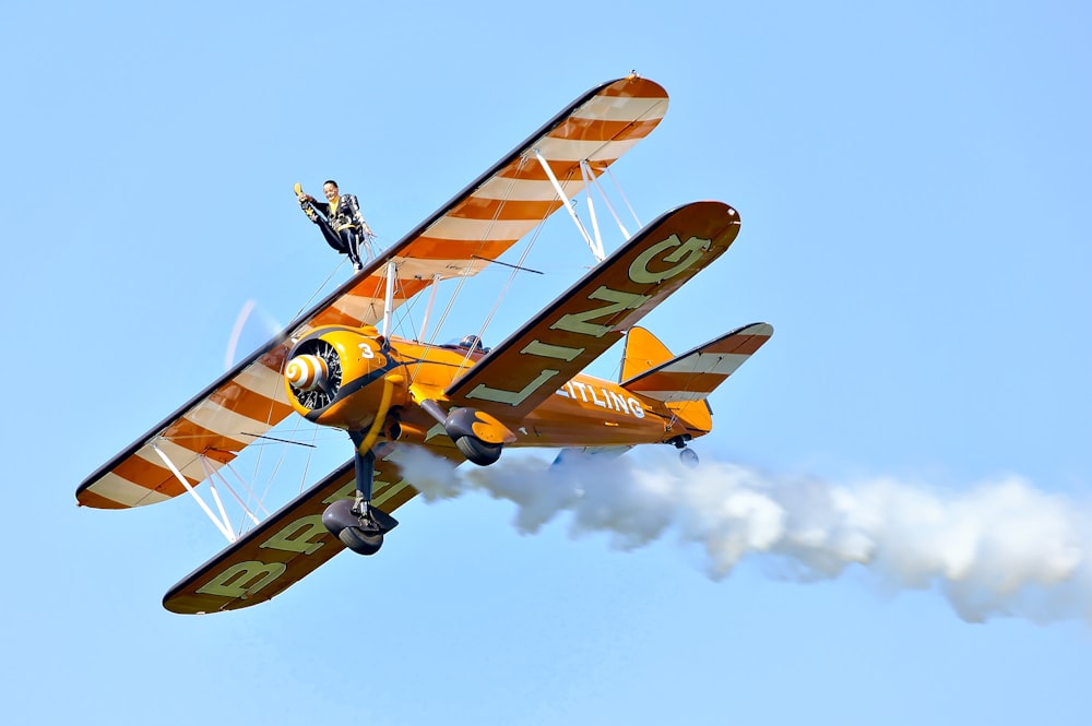 yellow biplane under blue sky during daytime