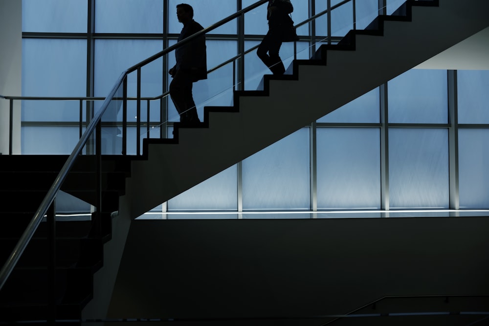 two person walking down on stairs