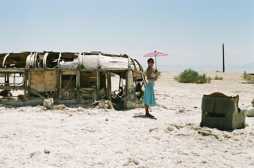 woman standing beside abandoned bus