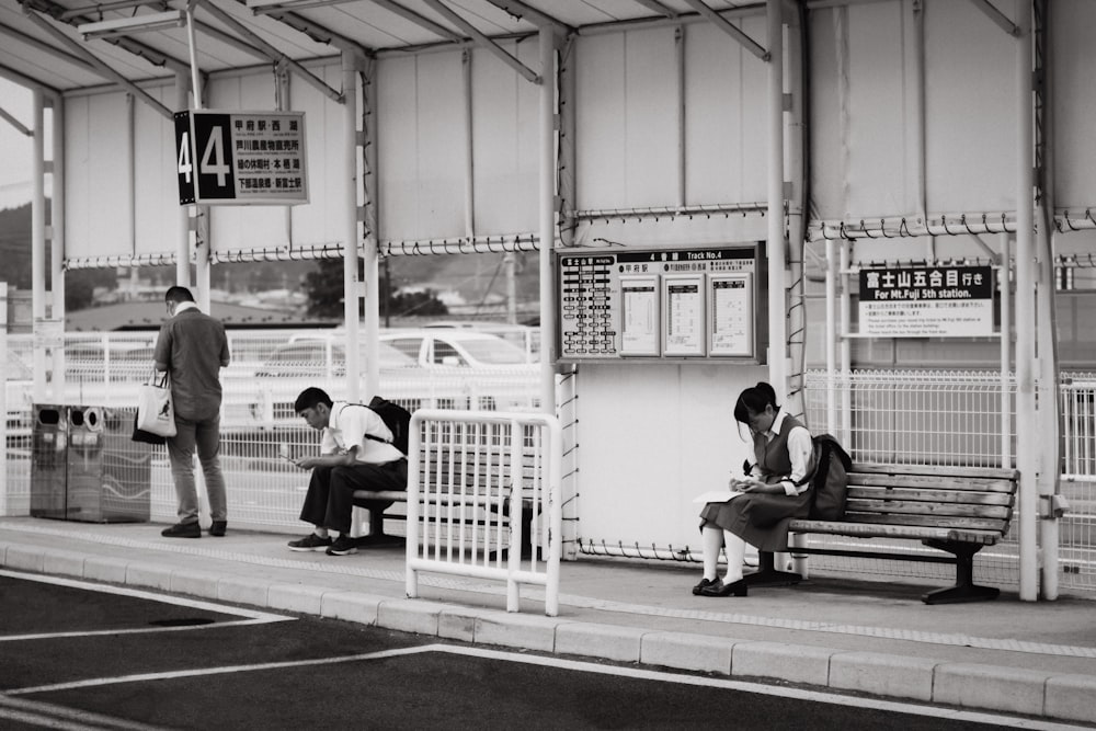 Schüler sitzen auf Bank in der Nähe der Bushaltestelle