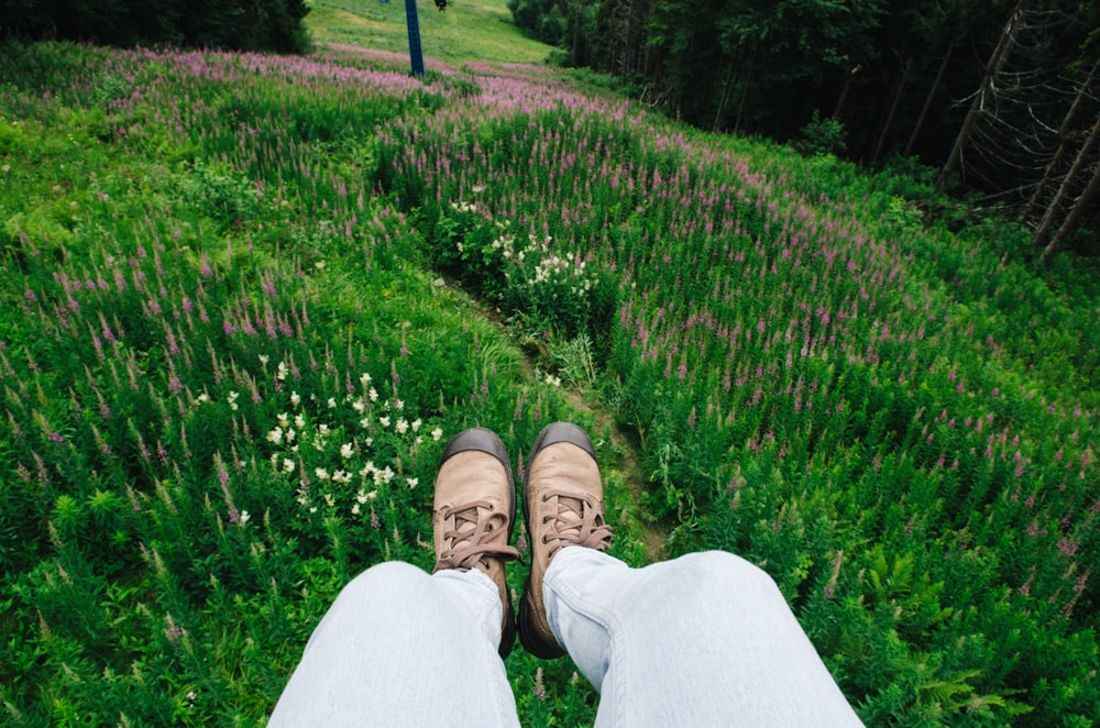 person surrounded by flowers during daytime