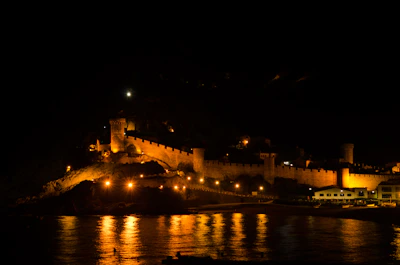 A medieval castle built by players at sunset with torches glowing