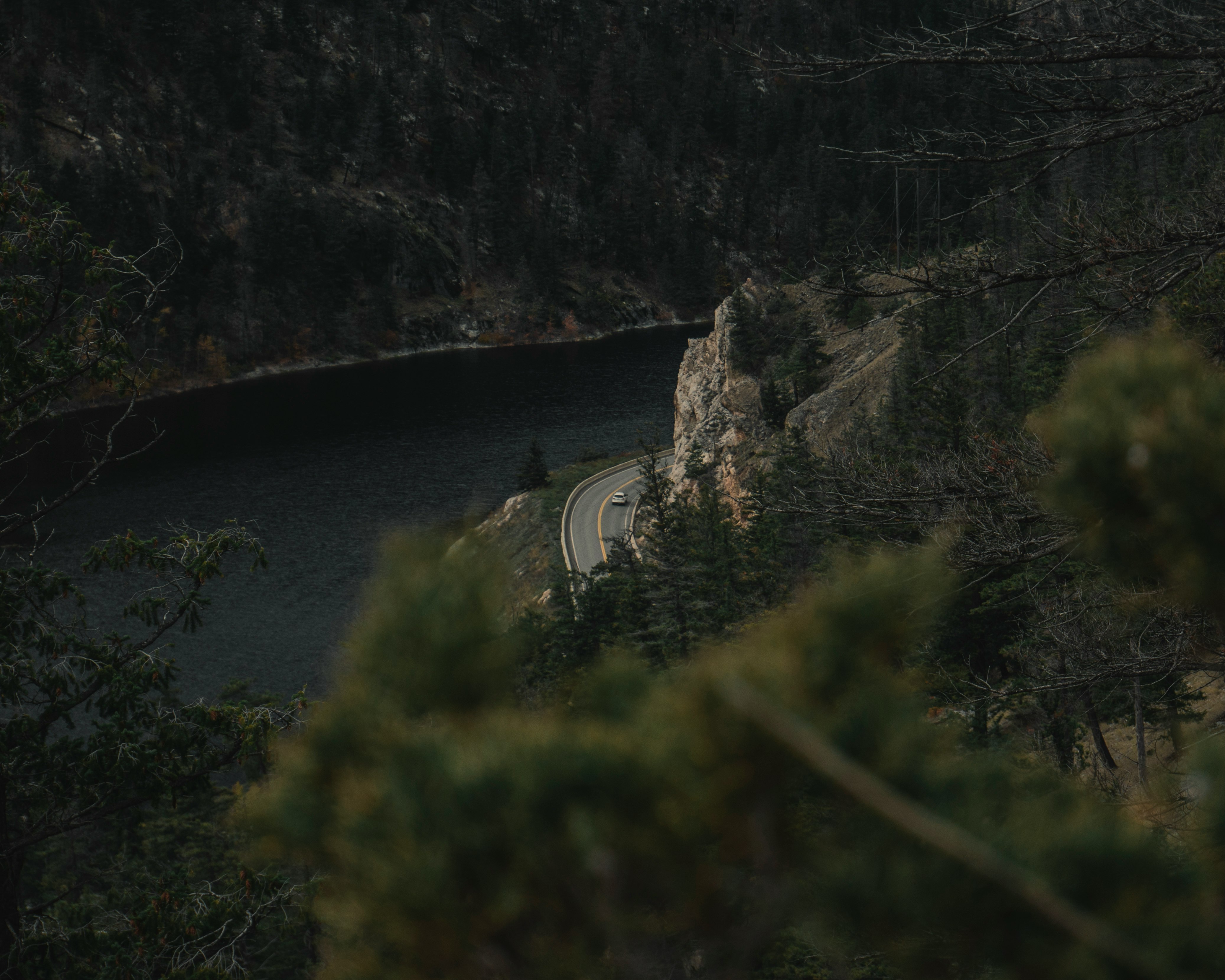 aerial photography of car crossing near body of water