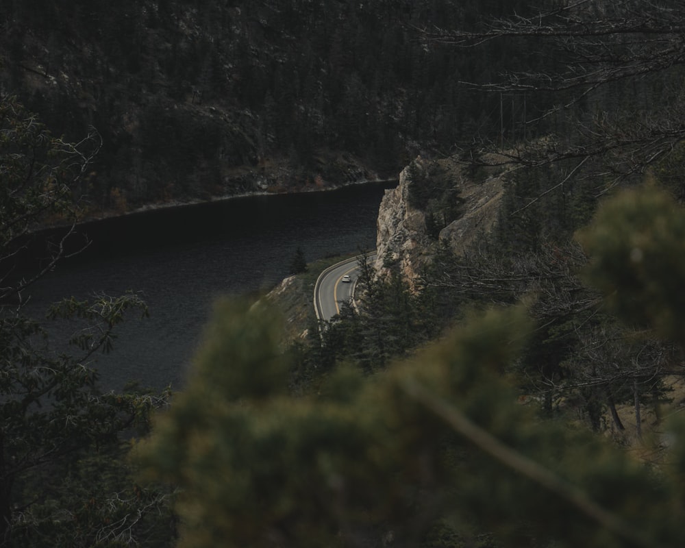 aerial photography of car crossing near body of water