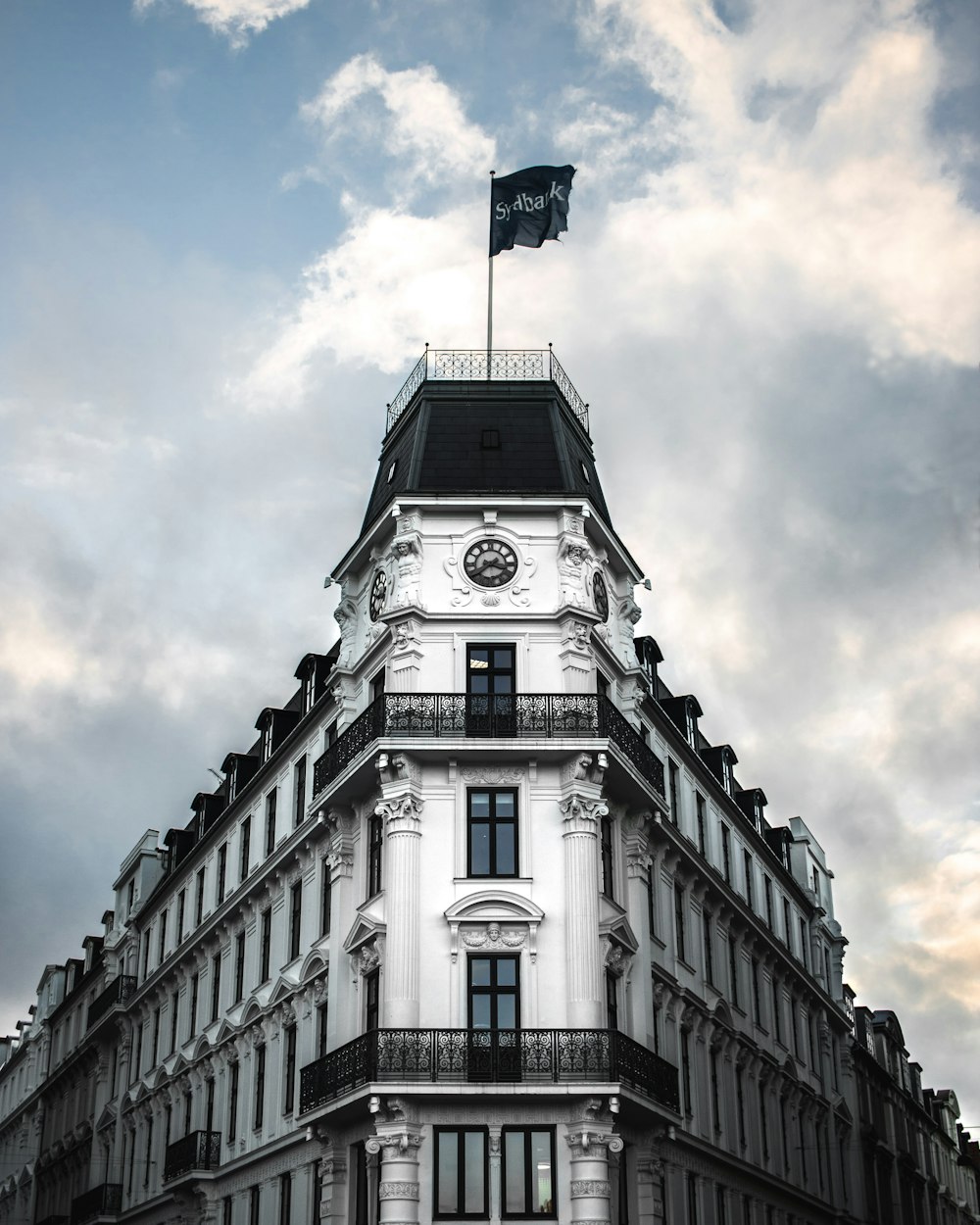 grayscale photography of castle with flag on top