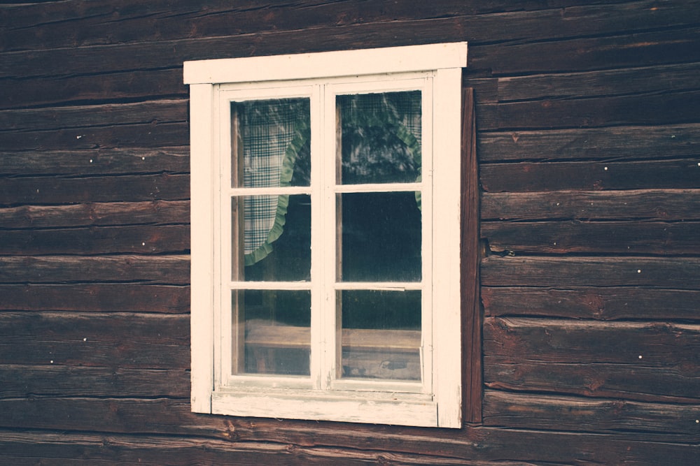 white framed window on brown wall