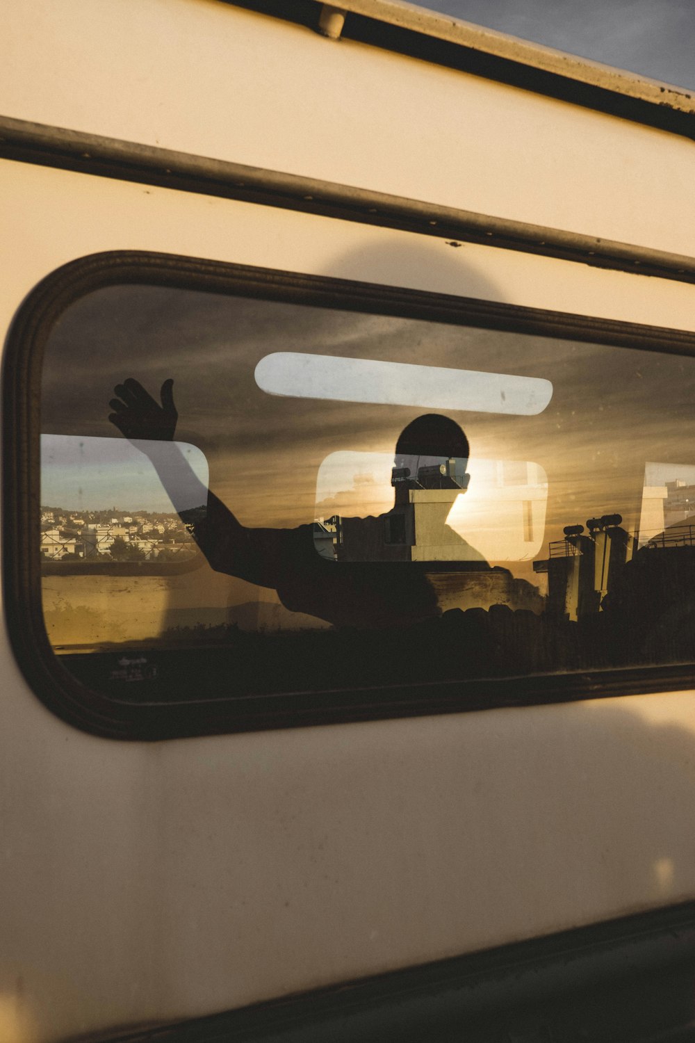 human shadow reflecting on vehicle window