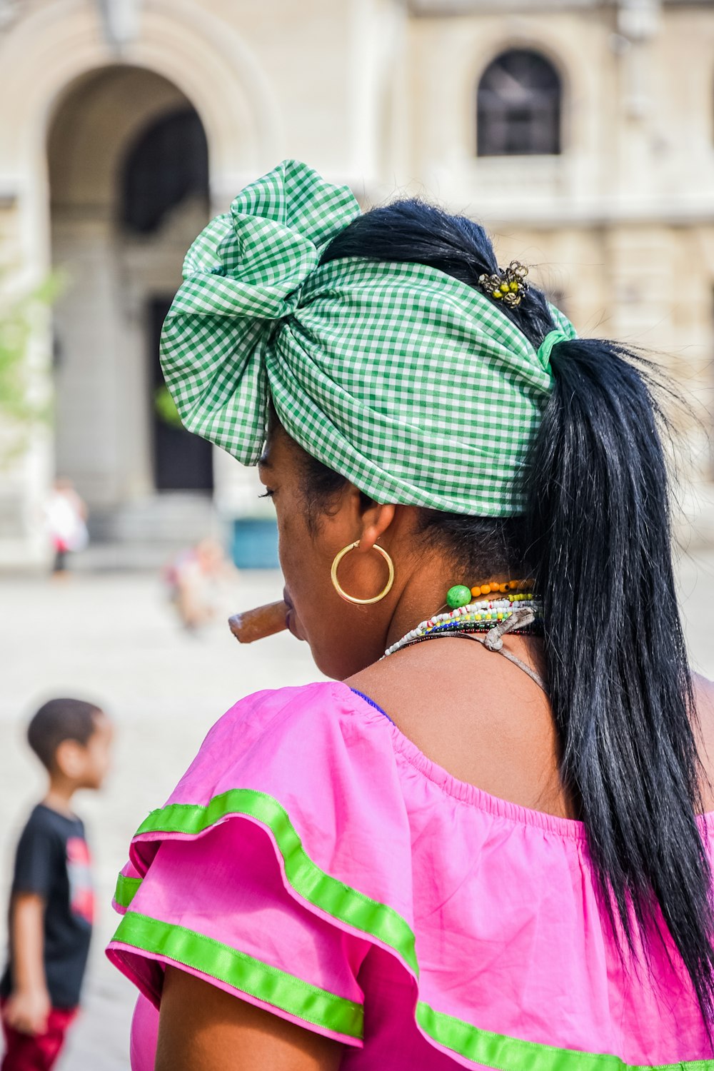 selective focus photography of woman wearing pink and green top