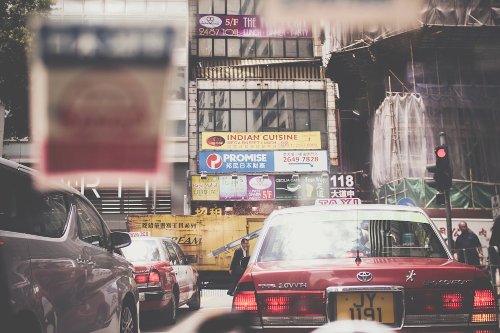 red car on traffic road during daytime