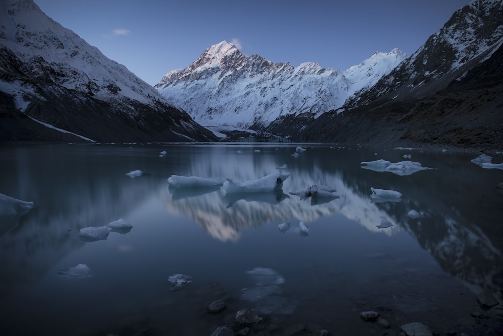 snow capped mountain near body of water during daytime