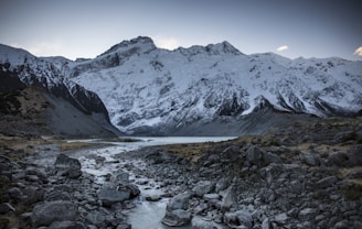 creek under glacier mountain and sky