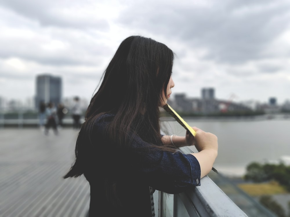 woman holding yellow envelope outside