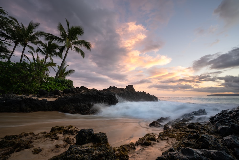 a rocky beach with waves crashing into the shore