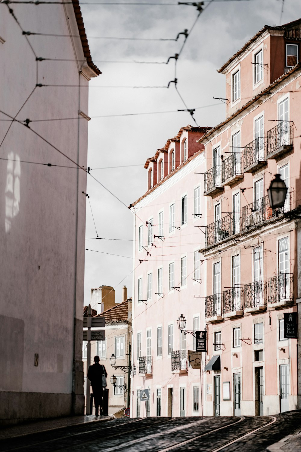 man standing beside building at daytime