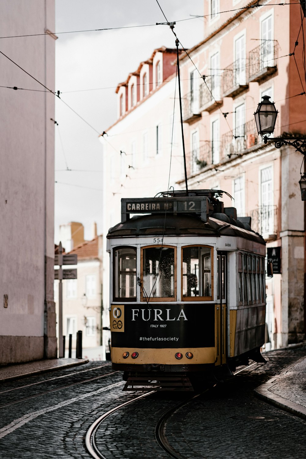 white and yellow Furla train at daytime