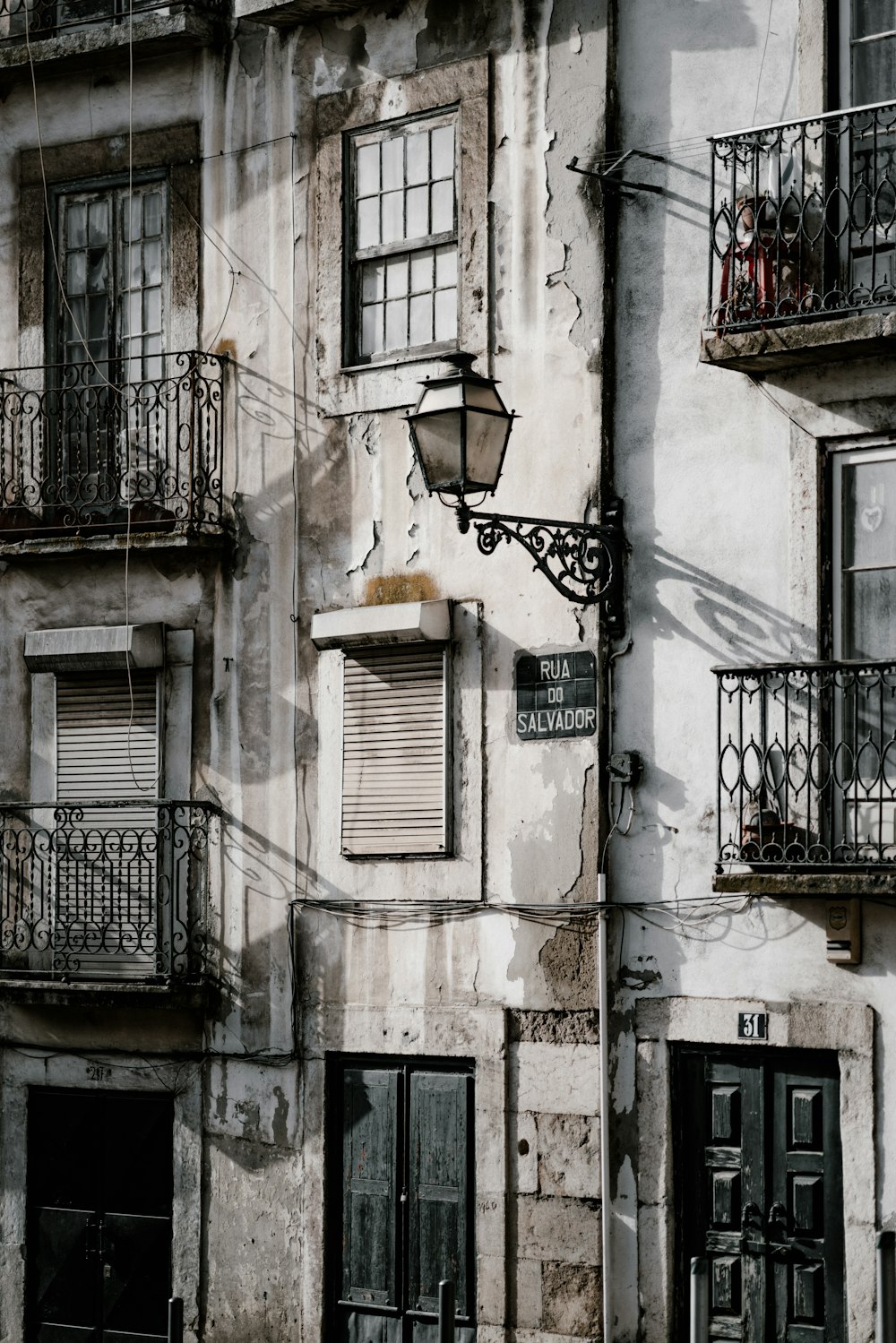 black metal outdoor lantern on building during daytime