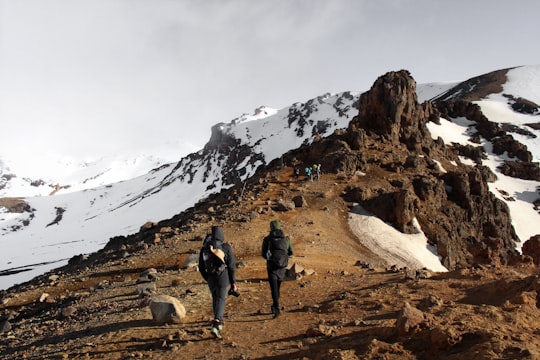 two man climbing mountain in Tongariro Alpine Crossing New Zealand