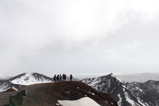 people standing on landscape in Tongariro Alpine Crossing New Zealand