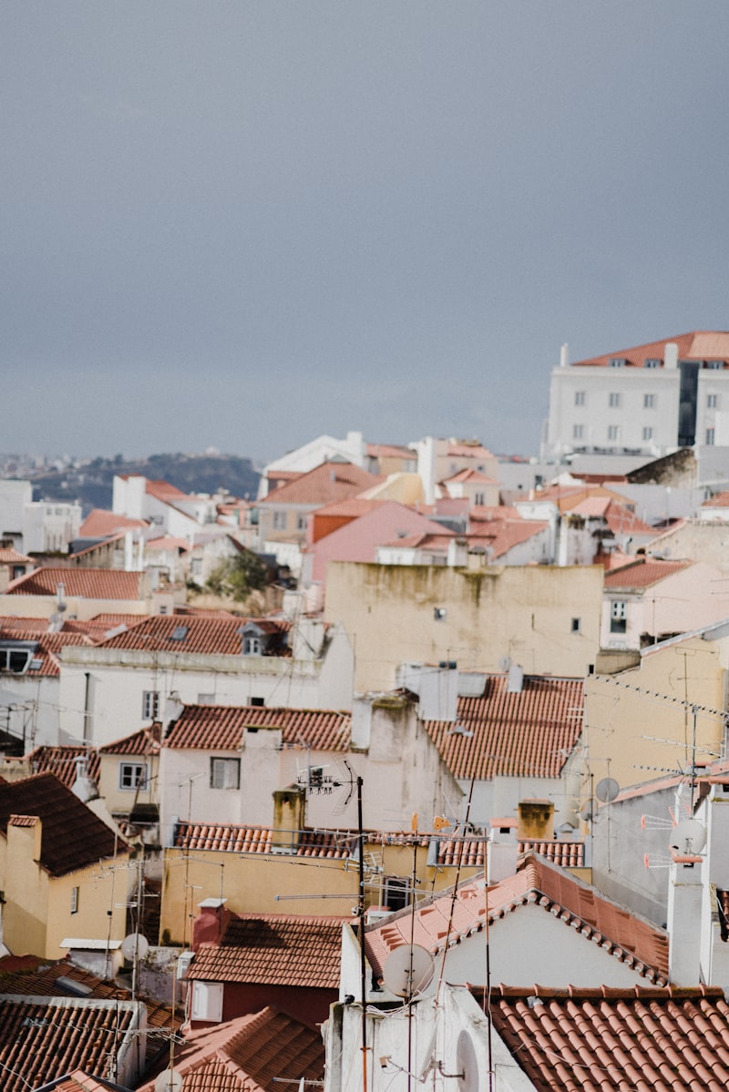 Panoramic view of Lisbon's historic rooftops and cityscape at sunset