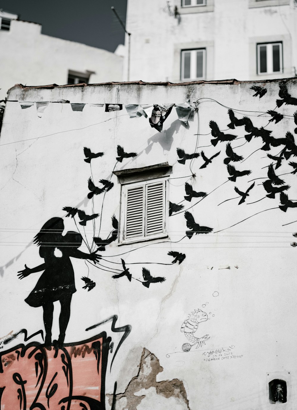 man and woman kissing each other with flight of bird graffiti