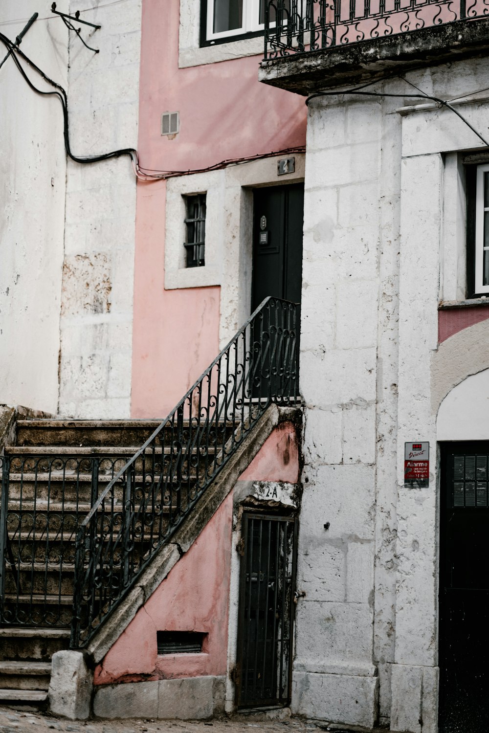 gray steel stair railings beside white concrete building