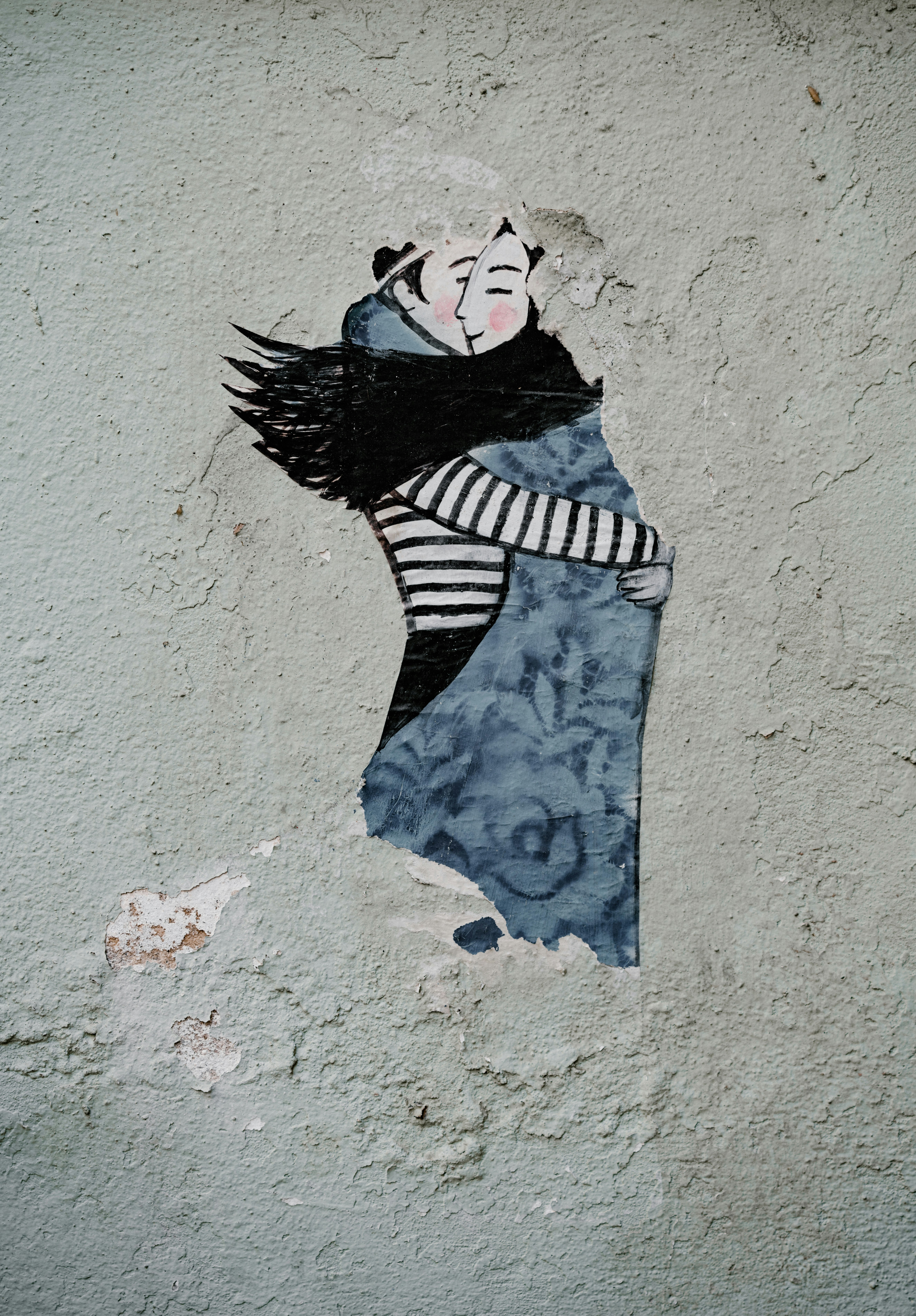 man hugging woman wall painting