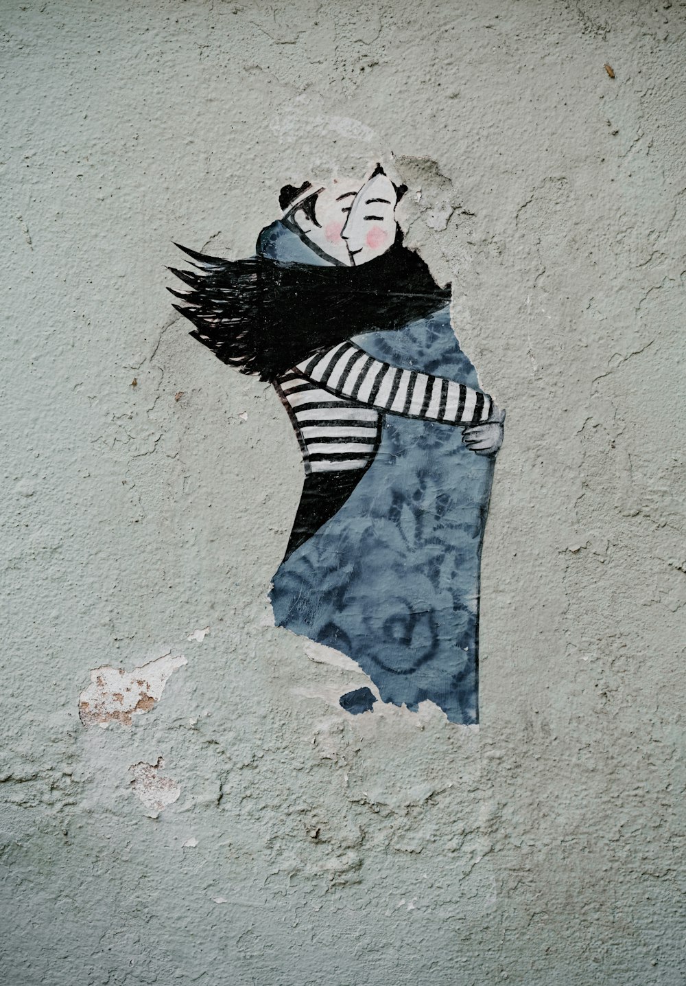 man hugging woman wall painting