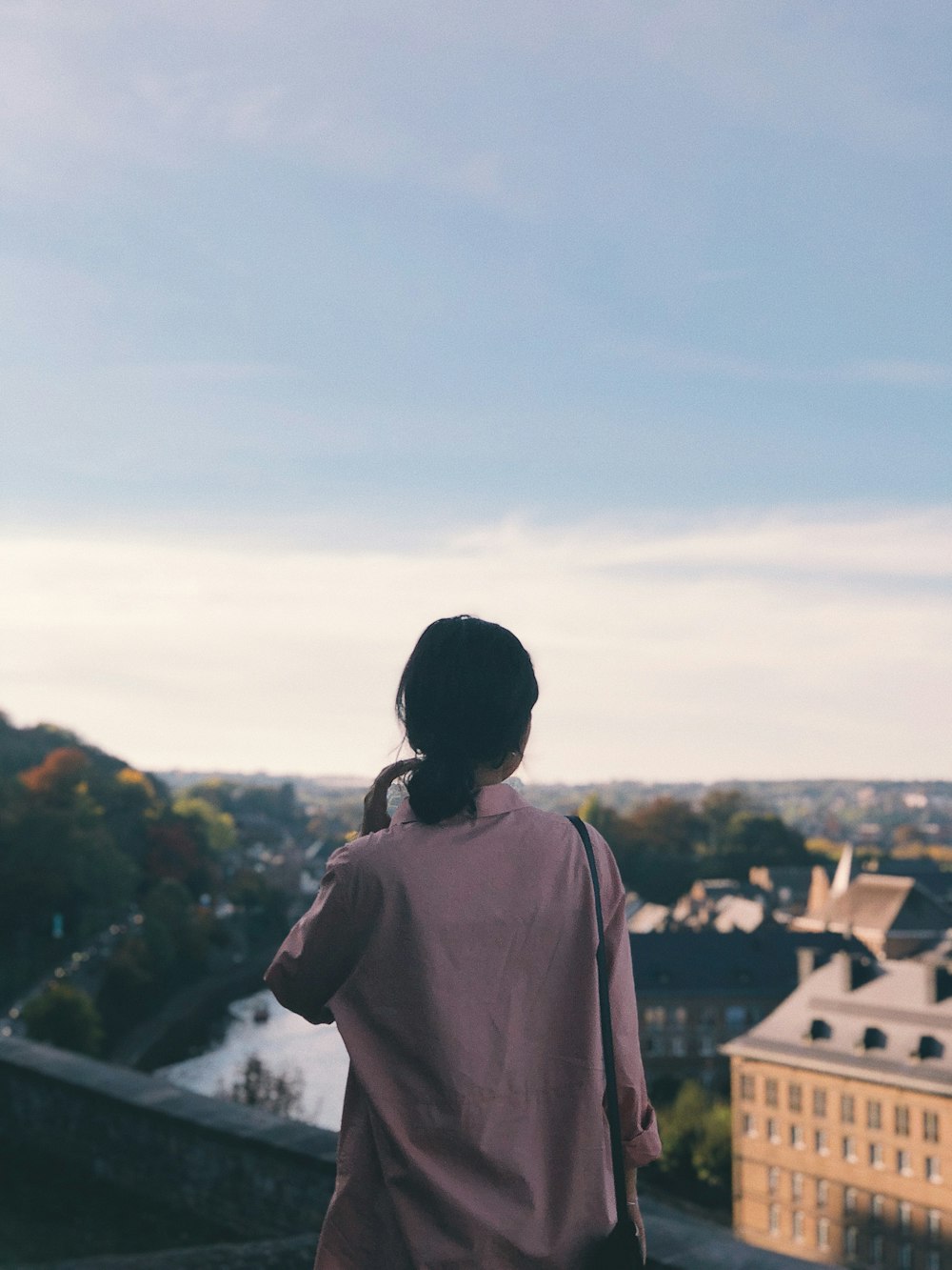 woman facing building structures