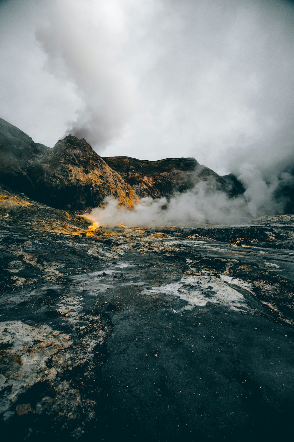 grey smoking mountain during daytime