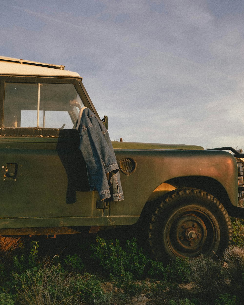 blue denim jacket on vehicle mirror