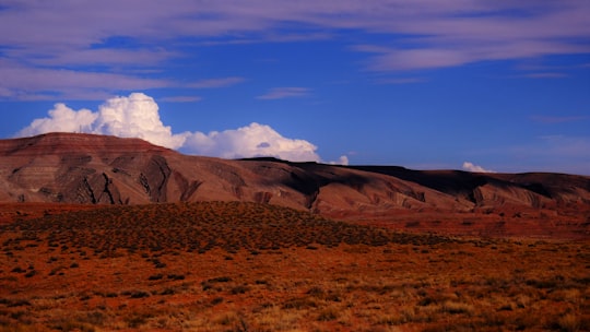 brown mountains under blue sky and white clouds during daytime in Mexican Hat United States