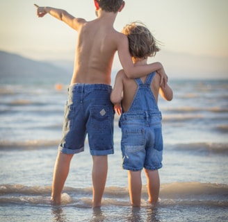 boy and girl standing at beach