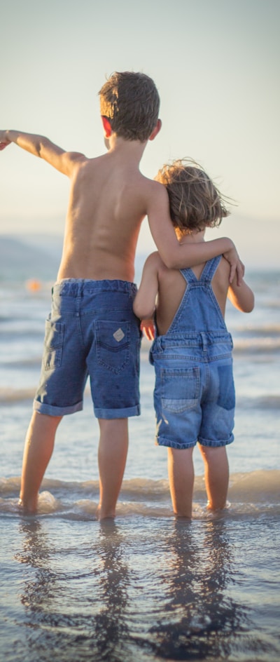 boy and girl standing at beach