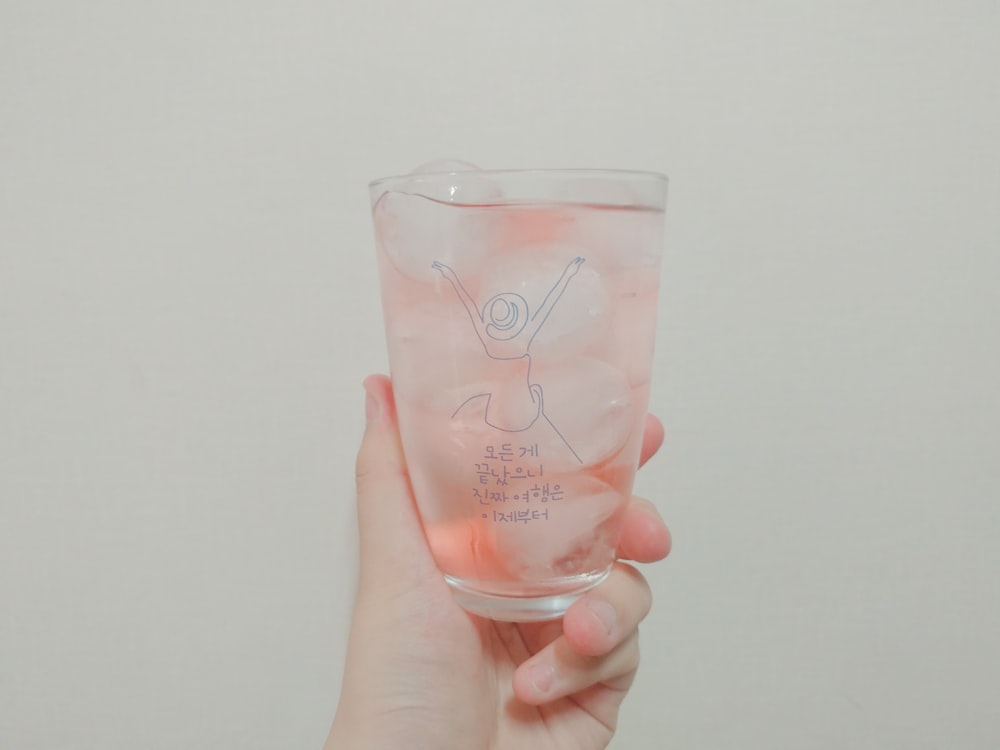 white liquid in clear glass cup