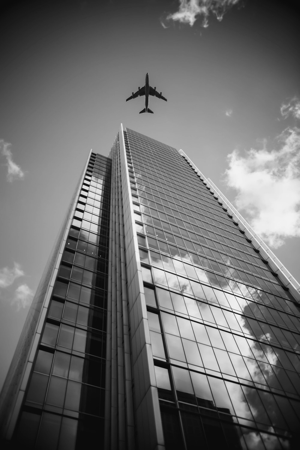 aerial photography of airplane near curtain wall building