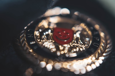 An intricate gothic emblem etched in deep crimson and black, glowing faintly.