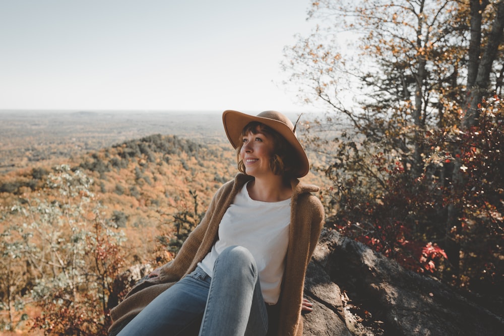 woman sitting on rock