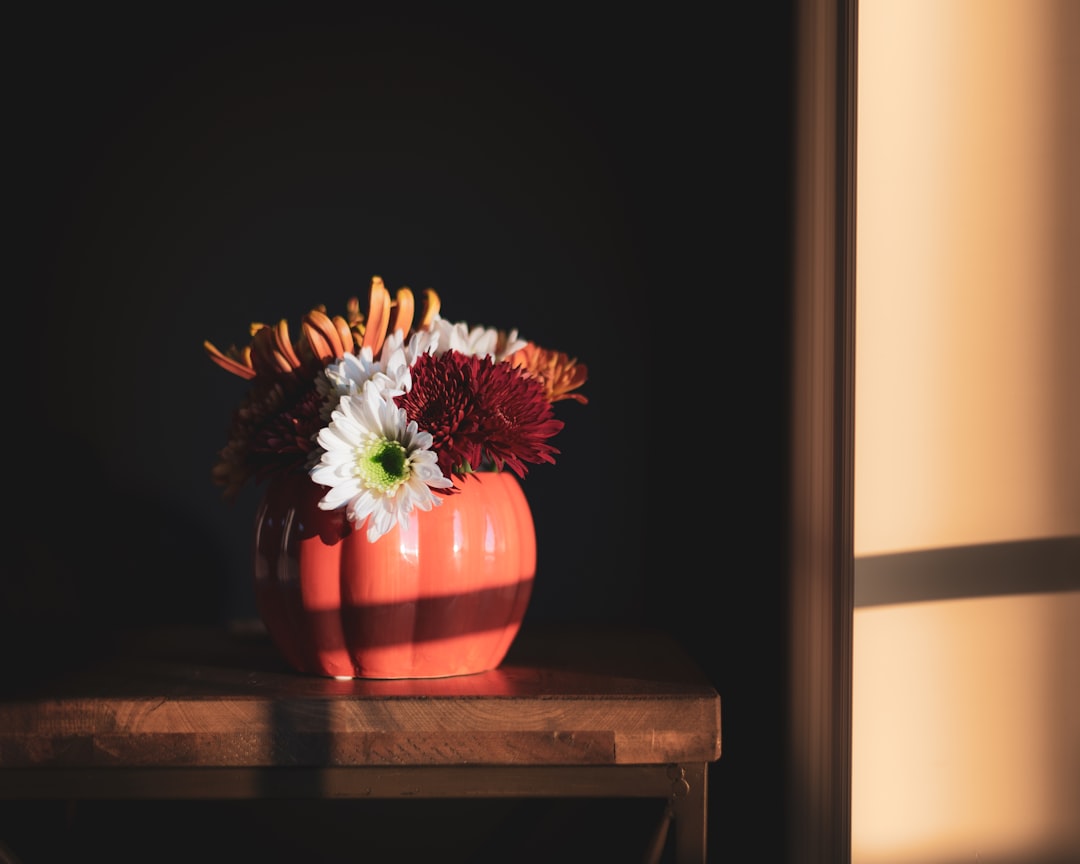 assorted-color petaled flowers centerpiece on table