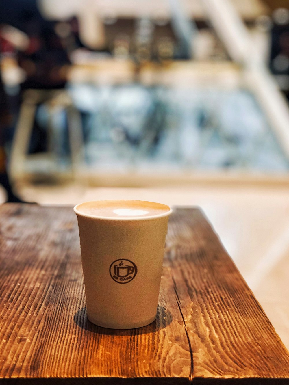 filled white disposable cup on table