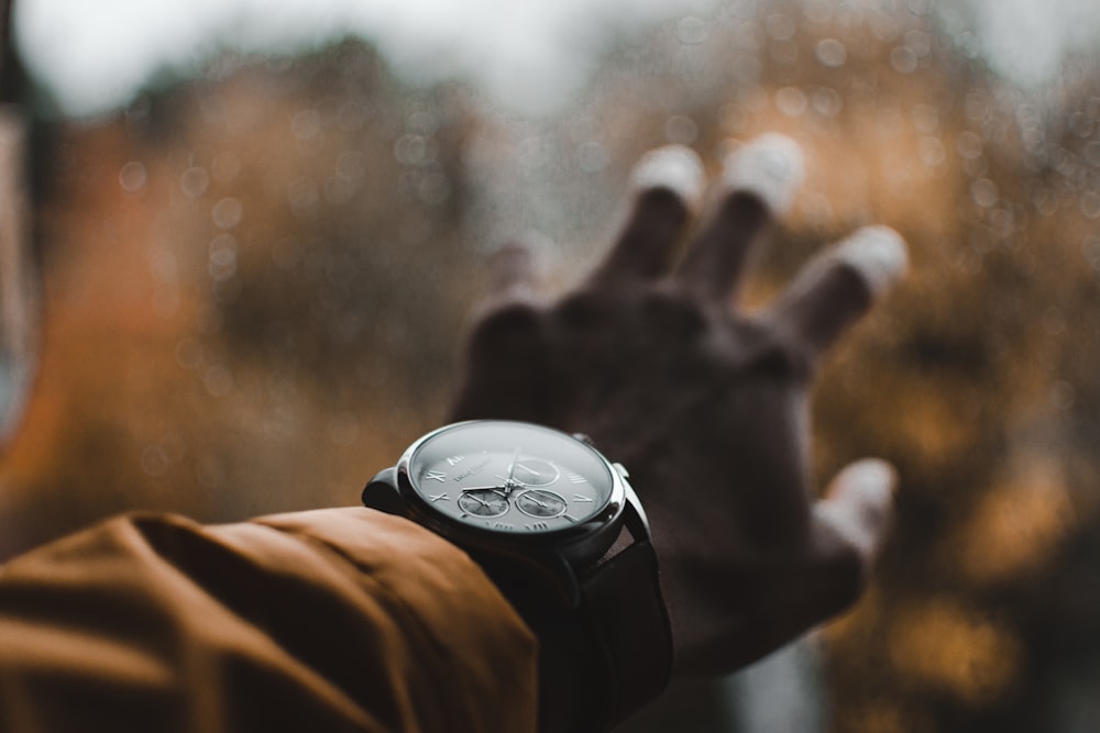 person wearing chronograph watch