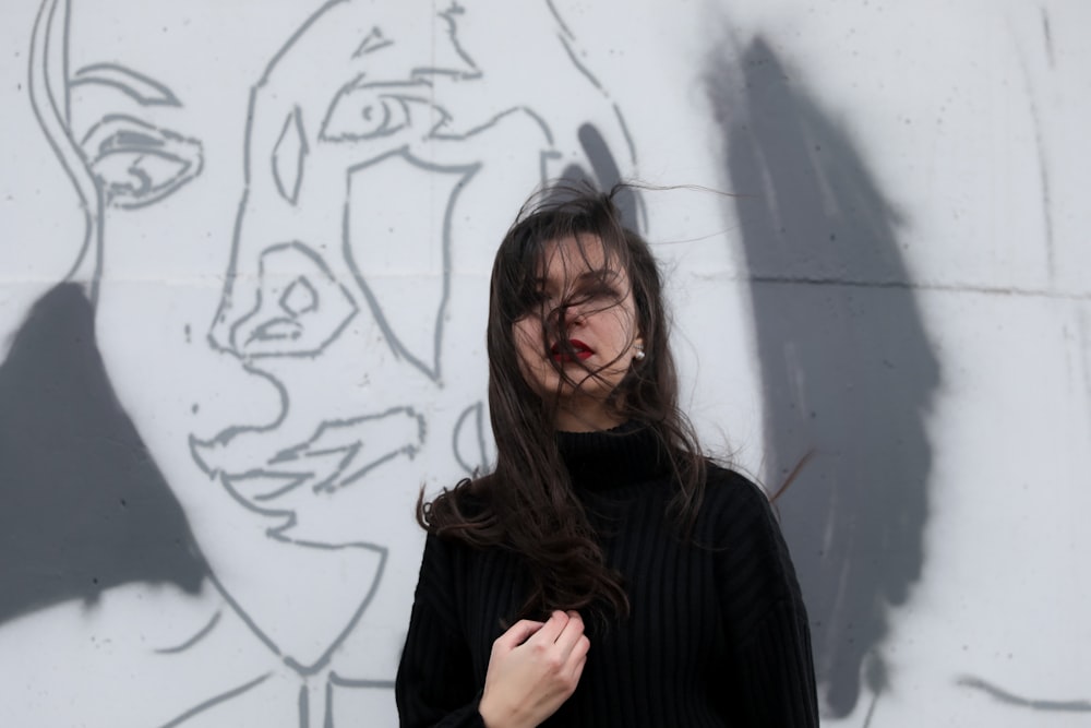 woman standing near white wall