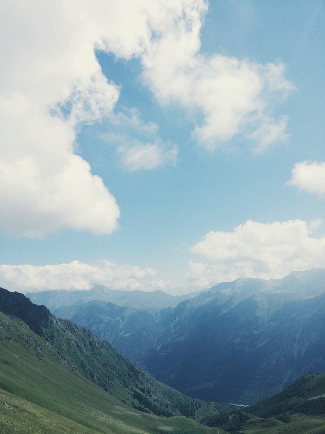 green mountain under white clouds