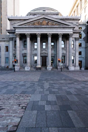 Neoclassical columned facade of a central-bank-style institutional building at dawn — visual reference for the Federal Reserve under new Chair Kevin Warsh