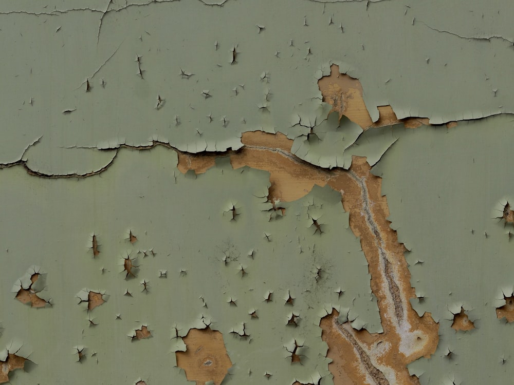 a close up of a peeling paint on a wall