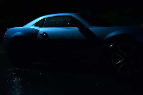 A dark reflective surface glistening after a fresh pressure wash under soft light blue hues.