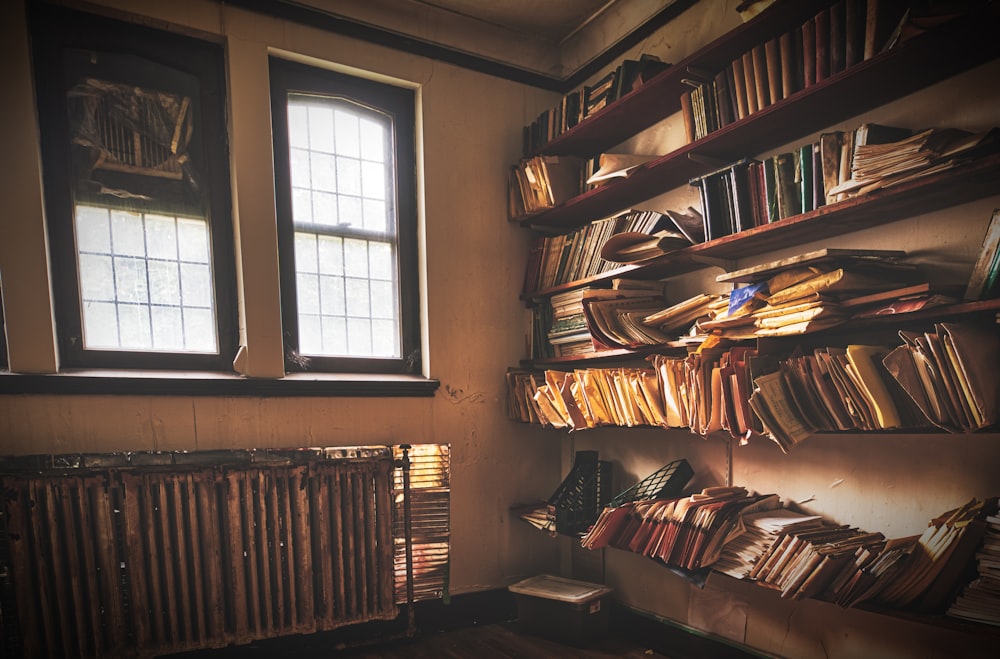 assorted books on rack near glass window