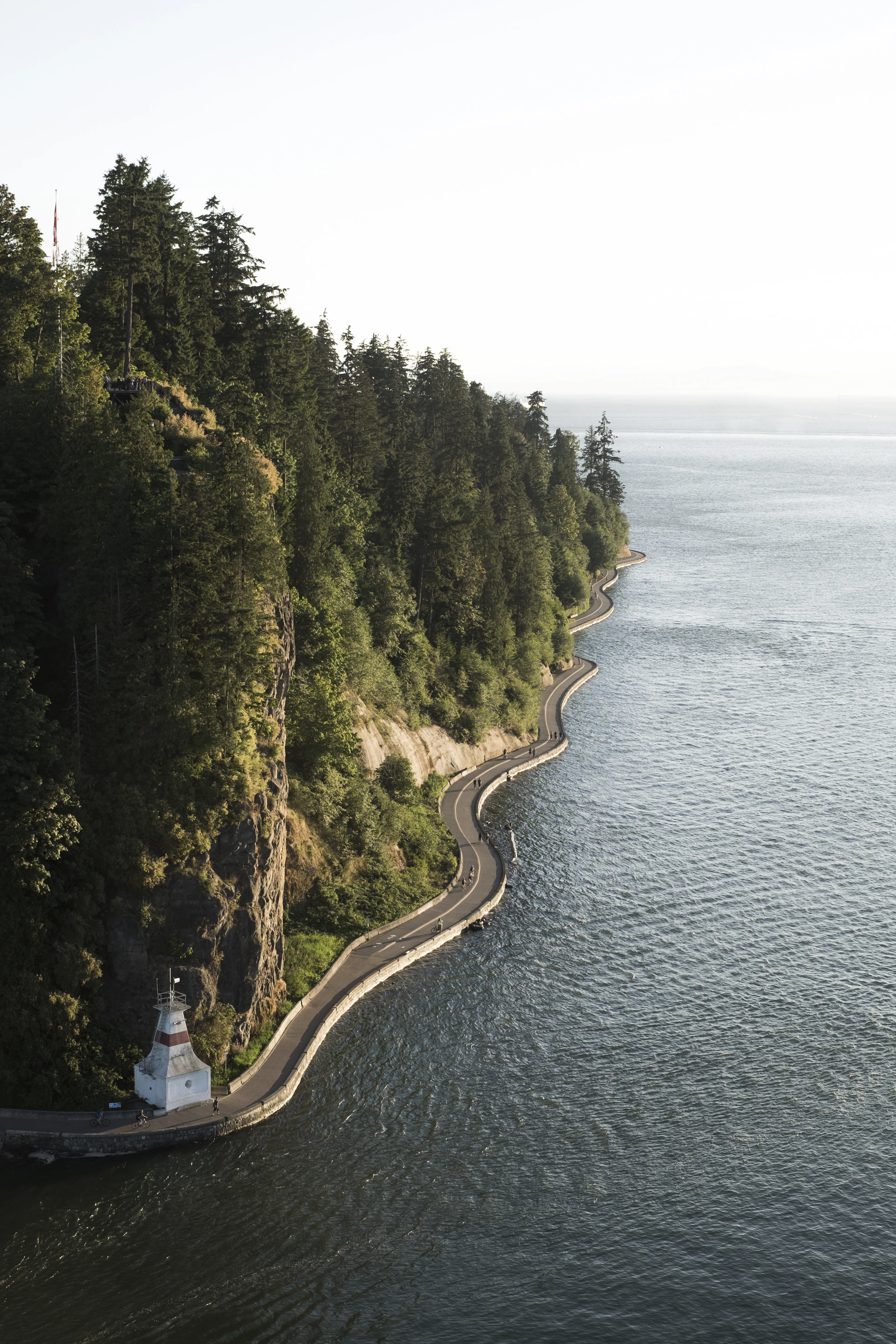 The Stanley Park seawall curving beneath the forested cliffs of Vancouver