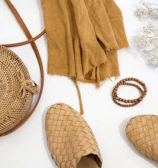 Flat lay of neutral-toned accessories styled with teesta’s signature pieces.