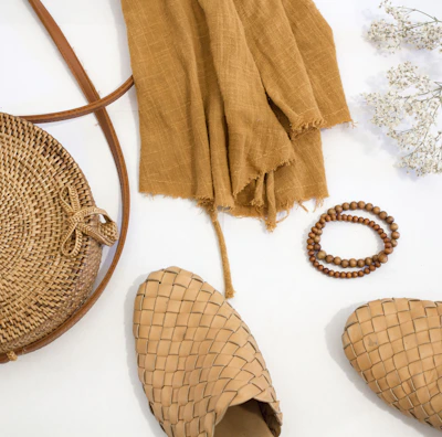 Flat lay of neutral-toned accessories styled with teesta’s signature pieces.