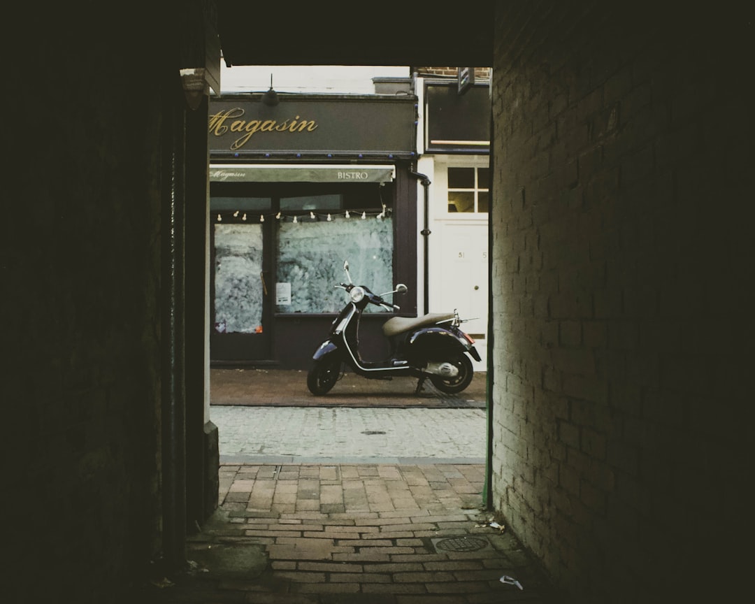 black automatic scooter as seen from alleyway,